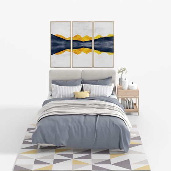 Modern grey upholstered bed with blue bedding and geometric rug on white background