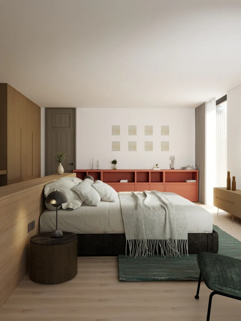 Modern bedroom featuring white bed, orange cabinet, wood wall panels, green rug, and circular table