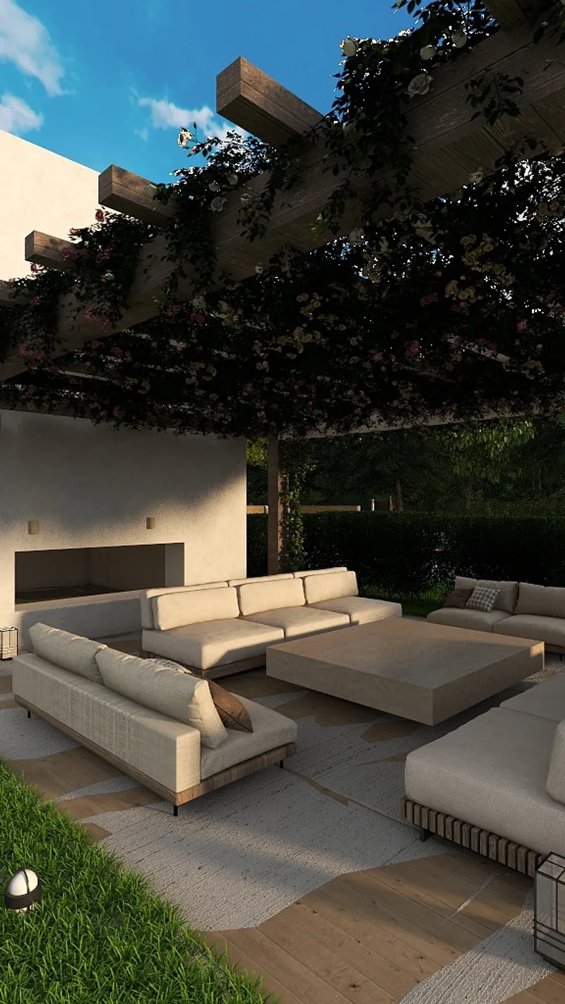 Modern outdoor seating area with cream sofas square coffee table and flower covered wooden patio