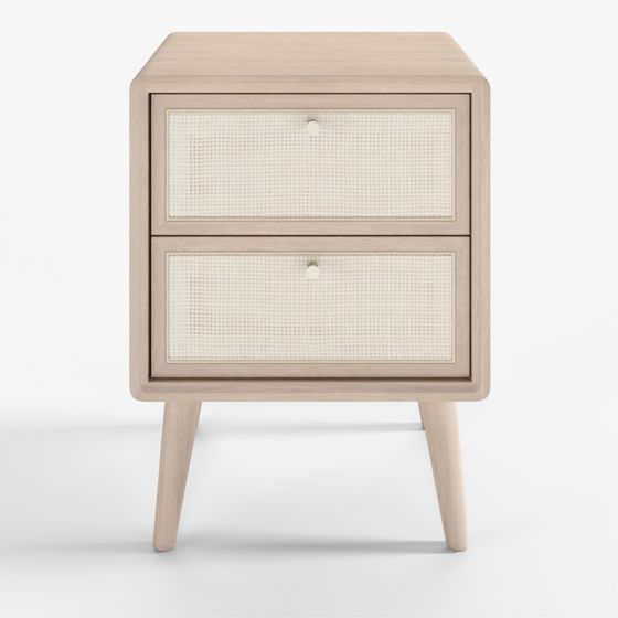 Modern light wood nightstand with cane drawers and gold knobs on grey background