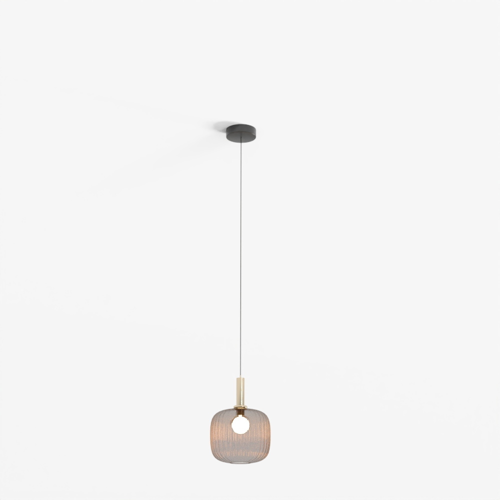 Modern hanging light with gold glass shade and black cord on grey background