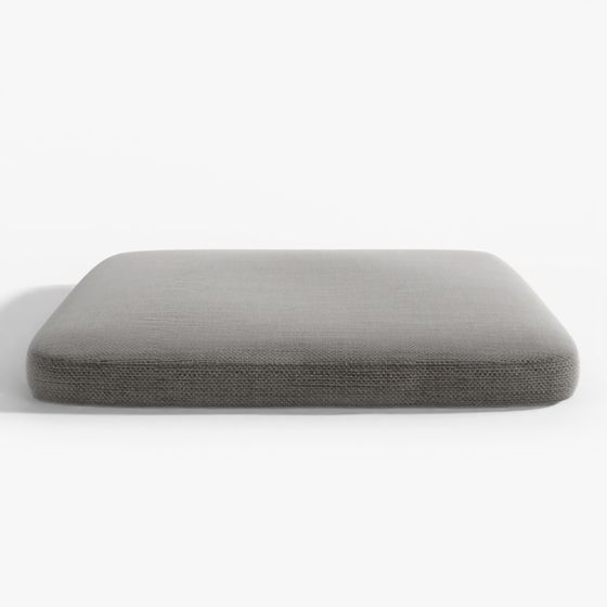 Square dark grey fabric cushion with textured surface and rounded corners on grey background