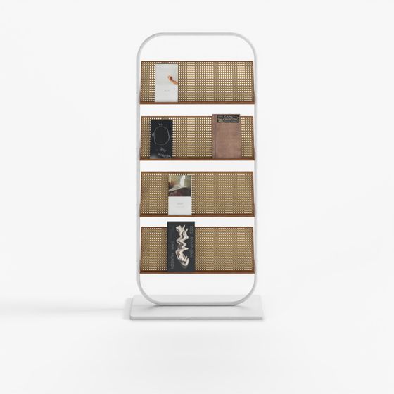 Modern white metal bookshelf with four brown cane shelves and books on white background